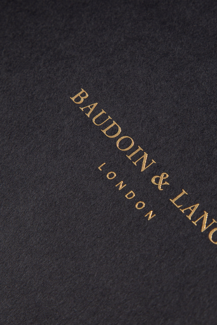 Paper in dark gray pulp colored and gold hot foil